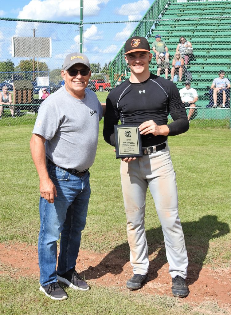 Commissioner Paul Riopel presenting the Bob Kootenay manager of the year award to Barrhead Orioles manager Chase Visser